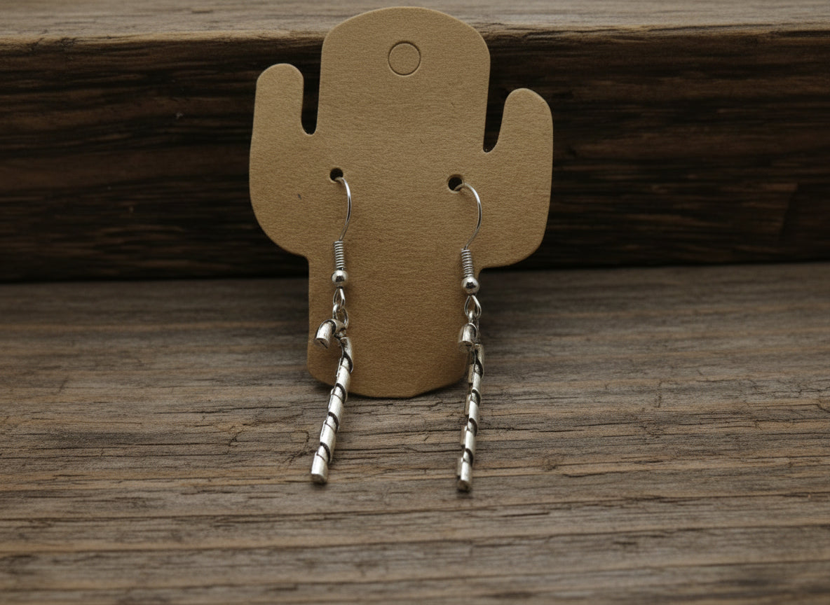 Silver, candy cane earrings on a brown cactus-shaped earring card against a white background